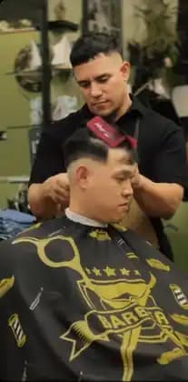 Carlos styling a client’s haircut at Tijeras Barbershop
